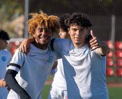 Two student athletes players Playing soccer Abroad from International Development Academy in Valencia Having Fun