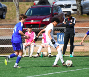 Goalkeeper coach steven fore coaching on the sidelines looking at a play